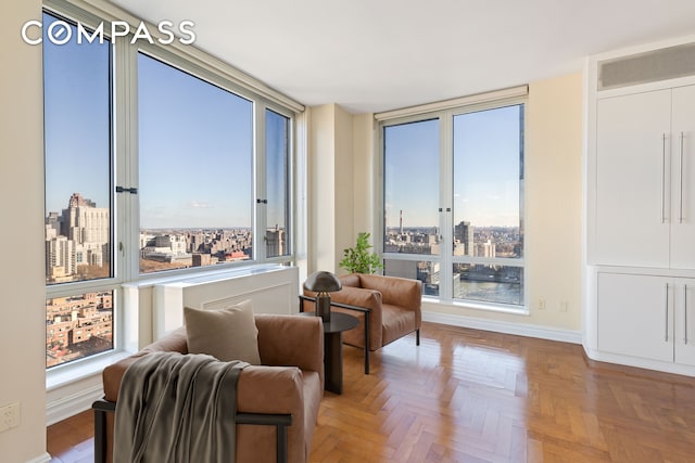 sitting room with parquet floors and a wealth of natural light