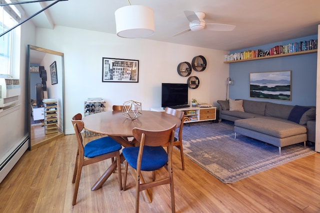 dining area featuring ceiling fan, light hardwood / wood-style floors, and a baseboard radiator