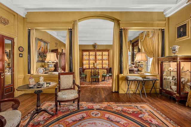 sitting room with dark hardwood / wood-style floors and ornamental molding