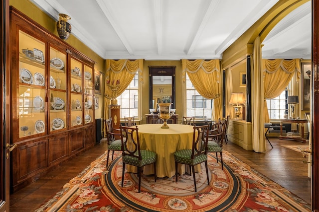 dining area with beam ceiling, dark hardwood / wood-style flooring, and ornamental molding