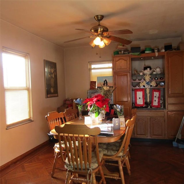 dining room featuring dark parquet flooring and ceiling fan