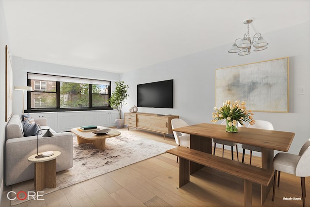 living room with light wood-type flooring and a chandelier