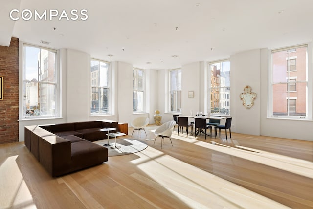 living room with light hardwood / wood-style flooring and a wall of windows