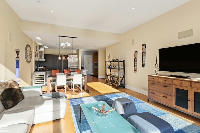 living room featuring light hardwood / wood-style floors and wine cooler