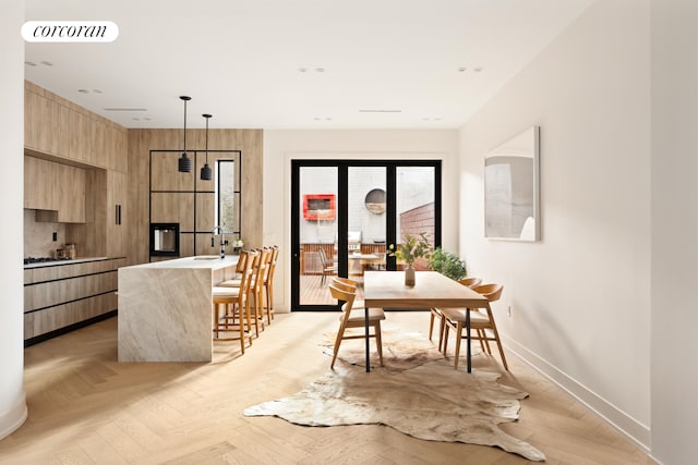 dining area with wood walls and light parquet flooring