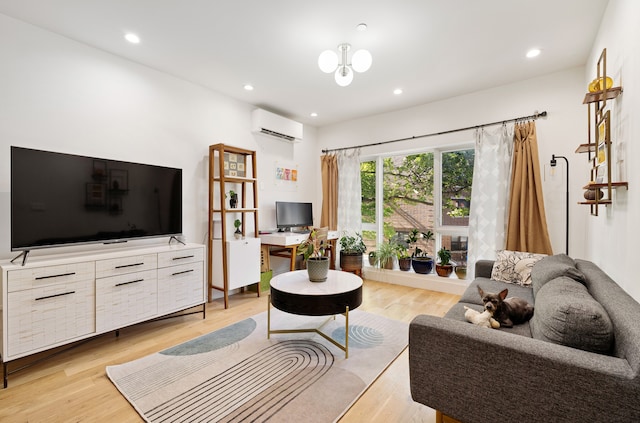 home office with light wood-type flooring and a wall mounted AC