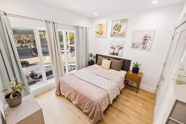 bedroom with a closet and light hardwood / wood-style flooring