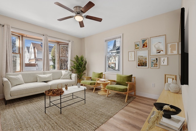 living room featuring light wood-type flooring and ceiling fan