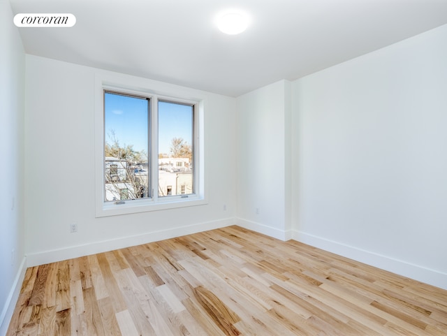 empty room with light hardwood / wood-style flooring