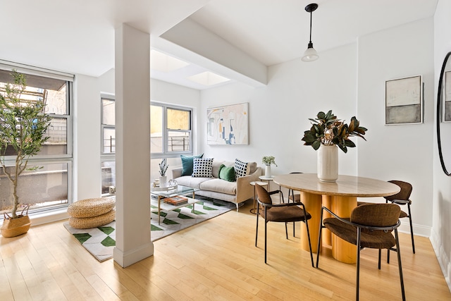 dining room featuring plenty of natural light and light wood-type flooring