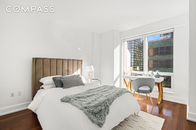 bedroom with dark hardwood / wood-style flooring