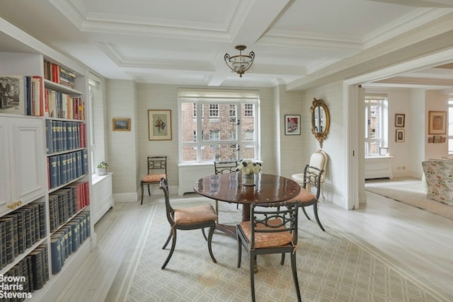 dining room featuring beamed ceiling, a healthy amount of sunlight, light wood-type flooring, and coffered ceiling