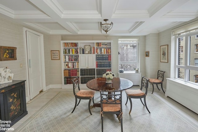 dining area with beamed ceiling, a chandelier, and coffered ceiling