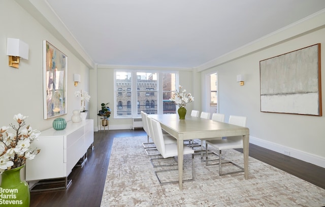 dining room featuring dark wood-type flooring and crown molding