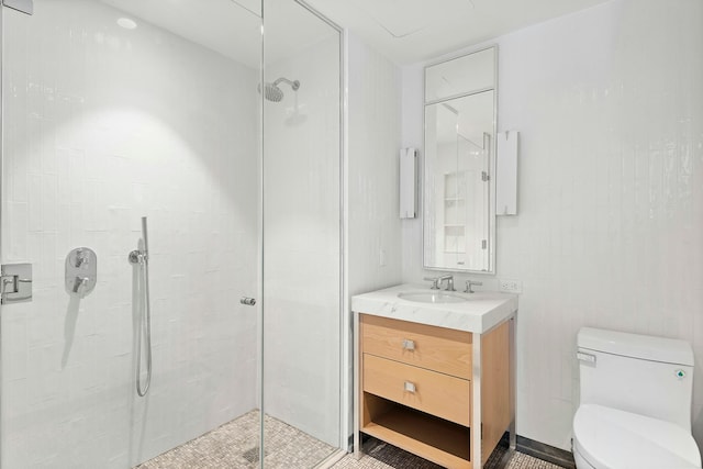 bathroom with vanity, toilet, and a tile shower