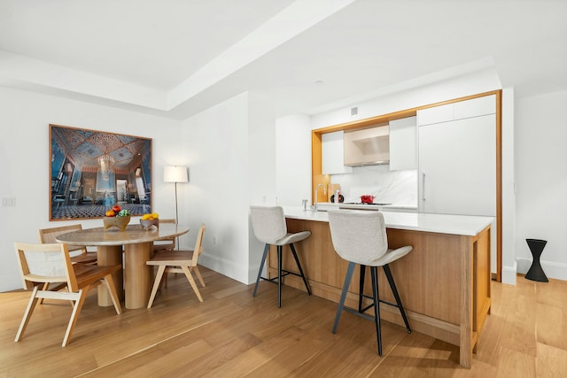 dining area featuring light hardwood / wood-style floors and sink