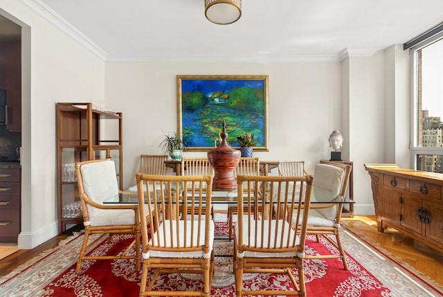 dining space featuring hardwood / wood-style flooring and ornamental molding