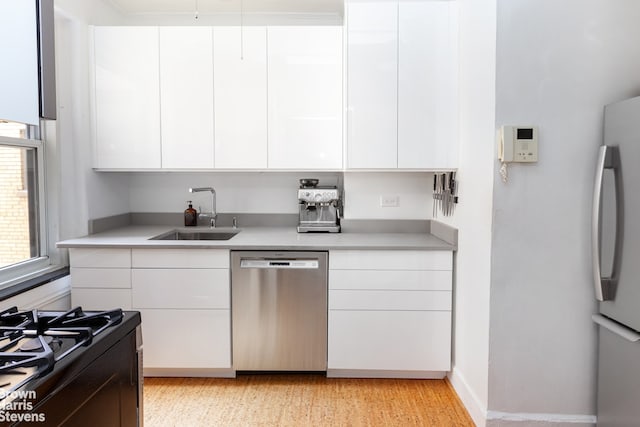 kitchen with white cabinetry, sink, and appliances with stainless steel finishes