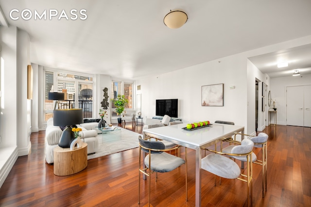 dining space featuring dark wood-type flooring