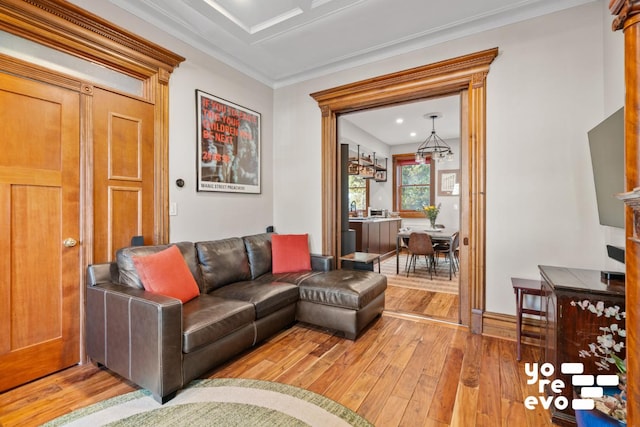 living room featuring wood-type flooring and crown molding