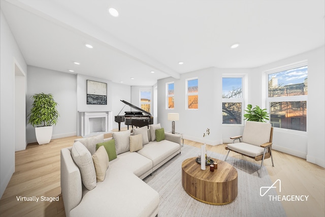 living room featuring beam ceiling and light wood-type flooring