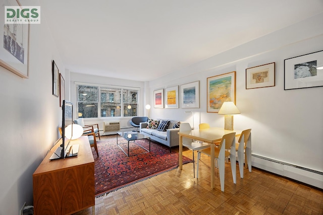 living room with baseboard heating and parquet flooring