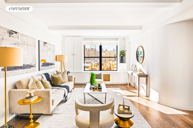 living room with hardwood / wood-style flooring and beam ceiling