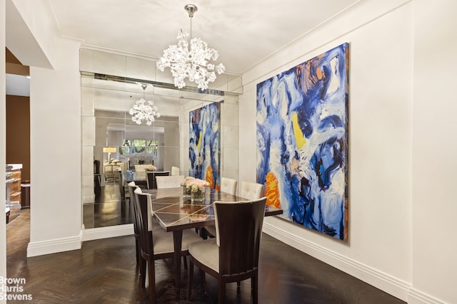 dining area featuring dark parquet floors, an inviting chandelier, and ornamental molding