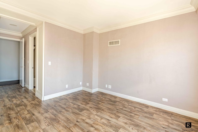 unfurnished room with hardwood / wood-style floors and crown molding