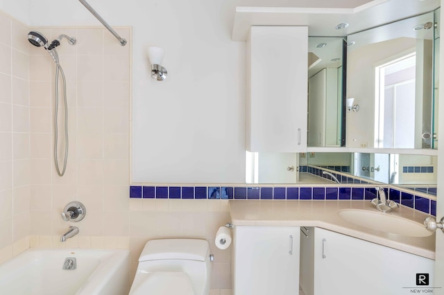 full bathroom featuring backsplash, vanity, tiled shower / bath combo, tile walls, and toilet