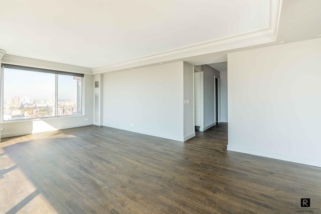 empty room featuring dark hardwood / wood-style flooring and crown molding