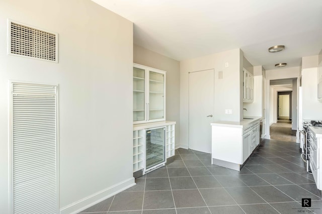 kitchen with sink, white cabinetry, and stainless steel range with gas stovetop