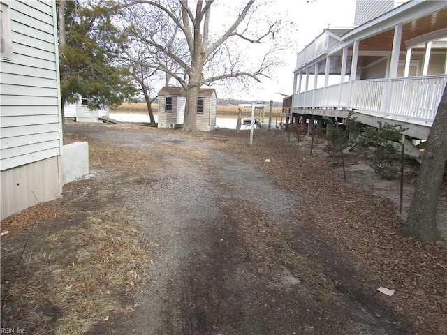 view of yard featuring a water view and a balcony