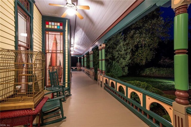 exterior space featuring decorative columns, ceiling fan, and wooden ceiling