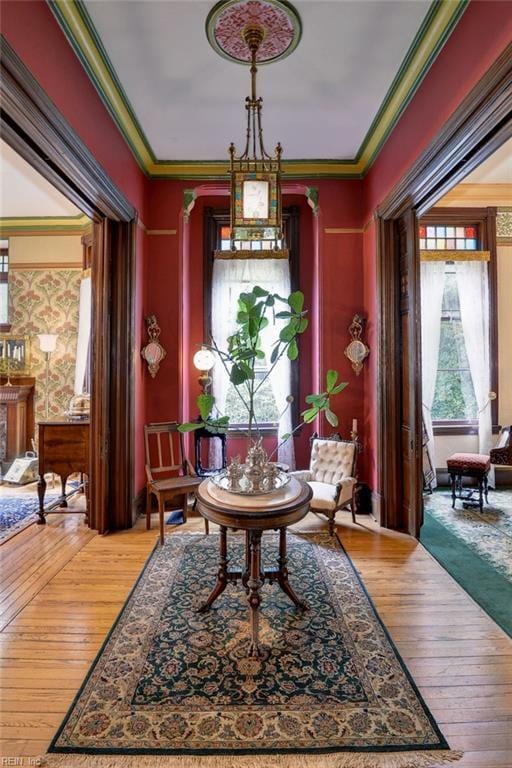 living area featuring dark hardwood / wood-style flooring and ornamental molding