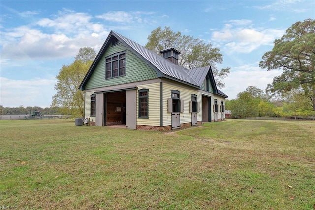 exterior space with central AC unit and a yard