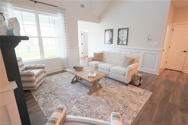 living room with dark hardwood / wood-style flooring and vaulted ceiling