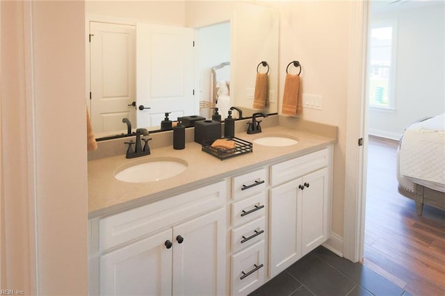 bathroom featuring hardwood / wood-style floors and dual bowl vanity