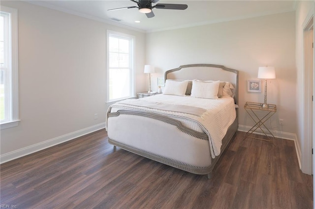 bedroom with dark wood-type flooring, crown molding, and ceiling fan