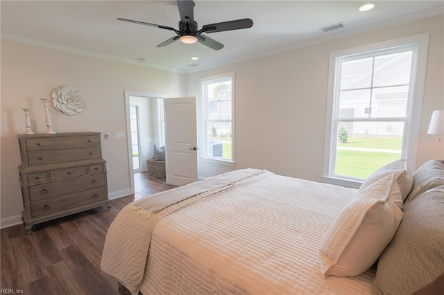 bedroom with ceiling fan, dark hardwood / wood-style floors, and crown molding