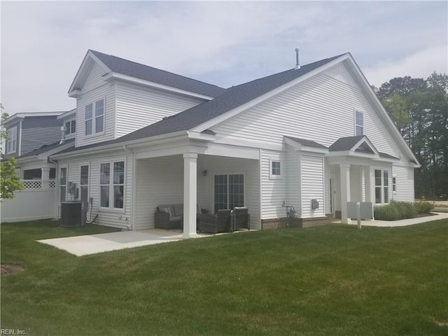 rear view of house with central AC unit, outdoor lounge area, a yard, and a patio area