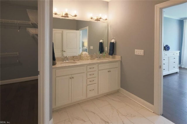 bathroom featuring double vanity and wood-type flooring