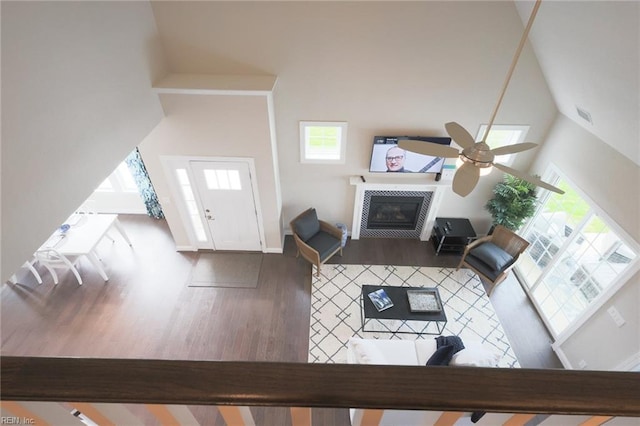 living room with high vaulted ceiling, a fireplace, ceiling fan, and hardwood / wood-style floors