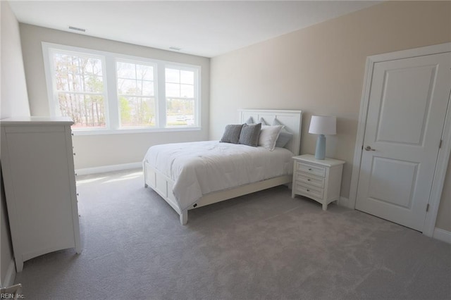 bedroom featuring light carpet