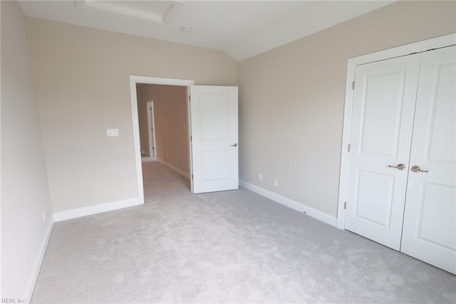 unfurnished bedroom with light carpet and a closet