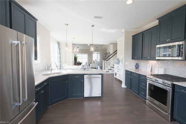 kitchen with sink, tasteful backsplash, dark hardwood / wood-style floors, and stainless steel appliances