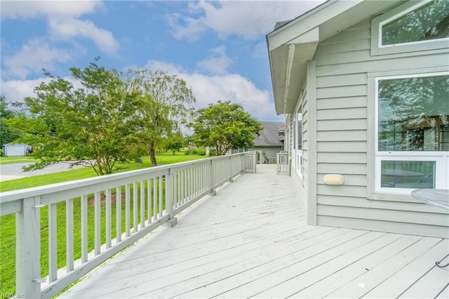 wooden deck featuring a yard