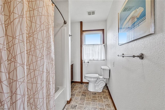 bathroom featuring shower / bath combo with shower curtain, toilet, and tile floors