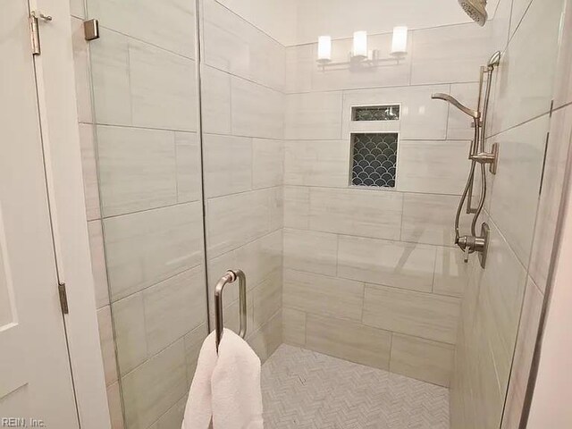 bathroom with a shower with door