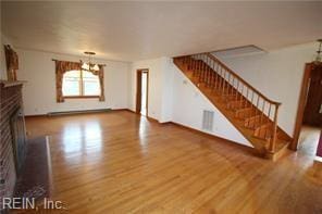 364 Millers Ln, Susan, VA 23163 - unfurnished living room with stairs, a fireplace, and wood finished floors